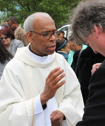 Newly ordained Rev. Jacques A. McGuffie gave his blessing after celebrating his first Mass on Sunday, May 26 at St. Patrick Church in Roxbury. He was one of five ordained by Cardinal O’Malley at the Cathedral on May 25. A native of Haiti, he earned degrees at Northeastern and Boston University and worked for the Mass Dept. of Social Services. After his wife’s death, he entered Pope John XXIII National Seminary for Delayed Vocations in Weston in August, 2009. He awaits his first assignment from the Cardinal this week.