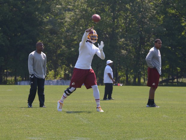 Washington Redskins quarterback Robert Griffin III throws a pass during NFL football training activity at Redskins Park in Ashburn, Va., Thursday, May 30.
