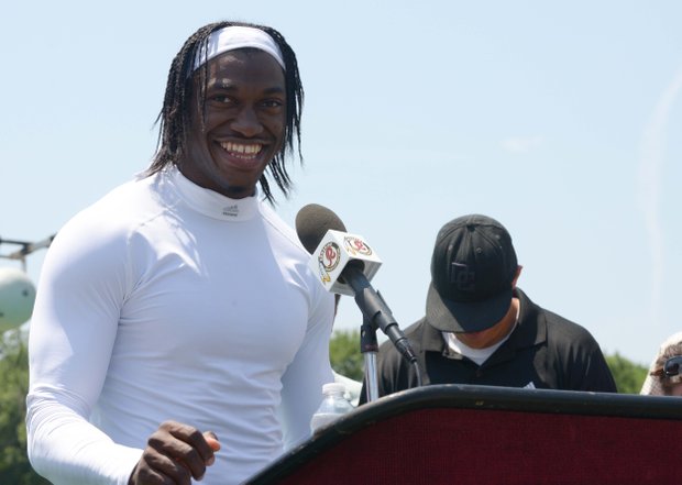 Washington Redskins quarterback Robert Griffin III takes questions from the media after NFL football training activity at Redskins Park in Ashburn, Va.,Thursday, May 30.