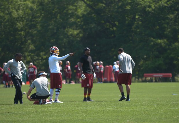 Washington Redskins quarterback Robert Griffin III throws a pass during NFL football training activity at Redskins Park in Ashburn, Va., Thursday, May 30.