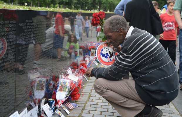 A visitor paying respects at the Vietnam Memorial on Monday, May 27, 2013.