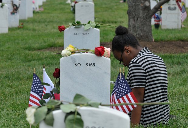 Remembering a loved one at Arlington Cemetery Monday, May 27, 2013.