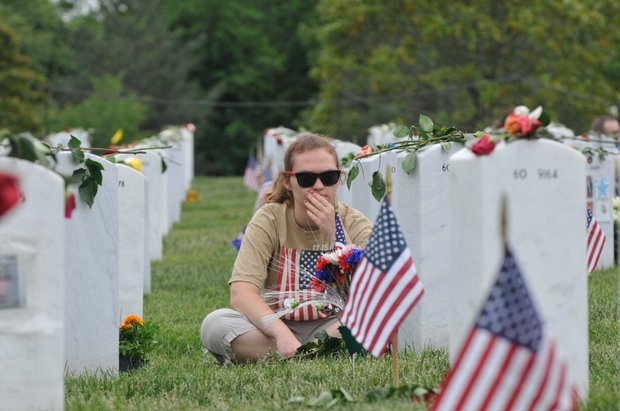 Remembering a soldier at Arlington National Cemetery on Monday, May 27, 2013.