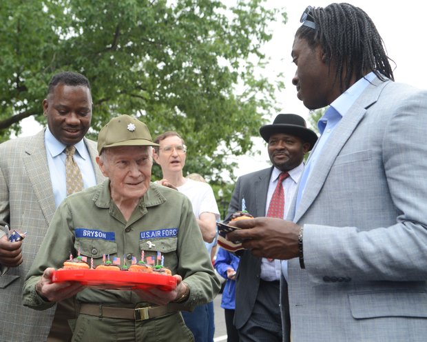 WWII Veteran Lt. Colonel Sam Bryson, 89 receives birthday wishes from Robert Griffin Jr. and Robert Griffin III after the Memorial Day parade on Monday, May 27, 2013.
