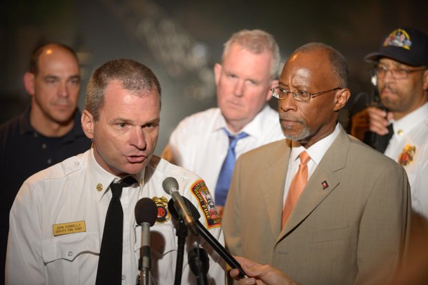D.C. Fire/EMS Deputy Fire Chief John Donnelly (left), with Deputy Mayor Paul Quander Jr. speaks to the media about the four-alarm blaze that destroyed Frager’s Hardware in Southeast on Wed., June 5.