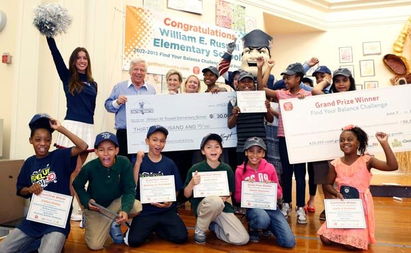 New England Patriots Chairman and CEO Robert Kraft awarded William E. Russell Elementary School Principal Tamara Blake-Canty with a surprise donation, matching a prize from the national Find Your Balance Challenge, to purchase the school a much-needed new kitchen. William E. Russell Elementary School in Dorchester was selected as the grand prize winner of the Find Your Balance Challenge by kickstarting a school-wide wellness initiative, working with students across all grades to create a community garden and form a student wellness council.