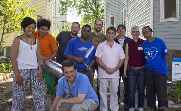 City Councillor Frank Baker and environmental advocate Joel Wool posed with members of Co-op Power, a multi-class, multi-racial movement for a sustainable and just energy future, as they came together to weatherize a property in the Bowdoin-Geneva area of Dorchester.