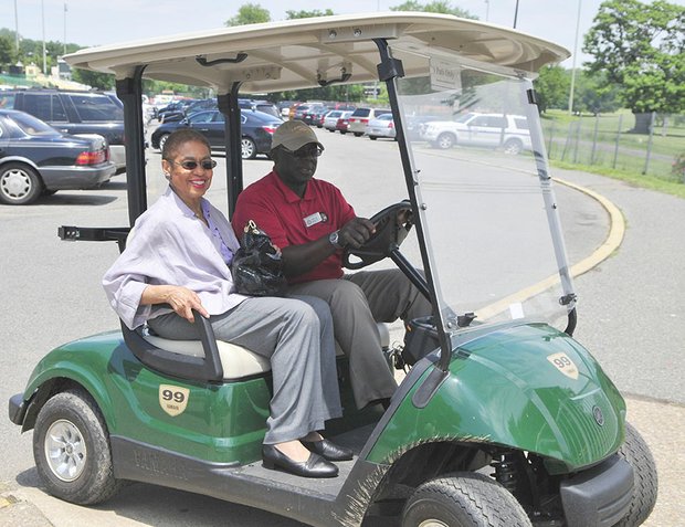Congresswoman Eleanor Holmes Norton an honorary guest at the Langston Golf Heritage Celebration held in Northeast in a golf cart driven by Mack McCauley.