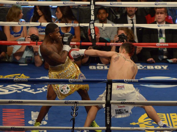 Adrien Broner (left), proved to be a hard target to hit as Paulie Malignaggi tries to land a punch during their championship bout at the Barclay's Center in Brooklyn, NY on Saturday, June 22. Broner who moved up two weight classes to fight Malignaggi won the welterweight title by a split decision.