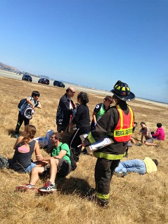The aftermath of Asiana Airlines flight 214 with 307 people on board, originated in Shanghai, China, and stopped in Seoul, South Korea. It was preparing to land in San Francisco when the rear of the plane struck the edge of the runway, severing the tail and causing the plane to erupt in smoke and flames.