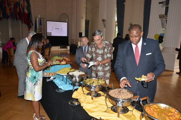 George Holmes samples the food during a celebration of the 40th anniversary of the Commonwealth of the Bahamas' independence at the Hall of the Americas OAS headquarters in Northwest D.C. on July 10, 2013.