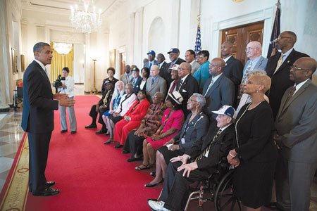 On Monday, President Barack Obama met with former Negro League baseball players in the Blue Room to honor
their contributions to our nation’s history, civil rights and professional baseball. Above are former Negro League
baseball players and their family members in the Cross Hall of the White House.