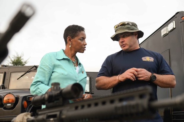Rep. Donna Edwards (D-Md.) receives SWAT instructions from Laurel, Md., Police MPO Jeff Van Cleave during the town's annual National Night Out in Granville Gude Park on Tuesday, Aug. 6. The yearly event gives Laurel's law enforcement and rescue personnel an opportunity to meet with the community.