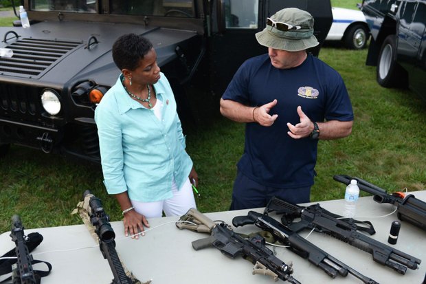 Rep. Donna Edwards (D-Md.) receives SWAT instructions from Laurel, Md., Police MPO Jeff Van Cleave during the town's annual National Night Out in Granville Gude Park on Tuesday, Aug. 6. The yearly event gives Laurel's law enforcement and rescue personnel an opportunity to meet with the community.