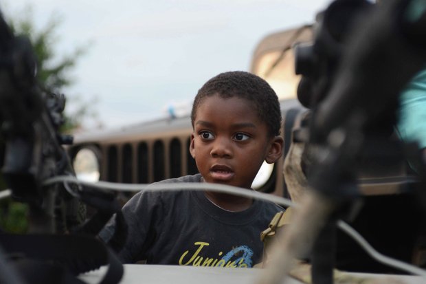Dorian Griffin Jr., 4, looks on during a demonstration by the Laurel, Md., Police Department SWAT team at the town's annual National Night Out in Granville Gude Park on Tuesday, Aug. 6. The yearly event gives Laurel's law enforcement and rescue personnel an opportunity to meet with the community.