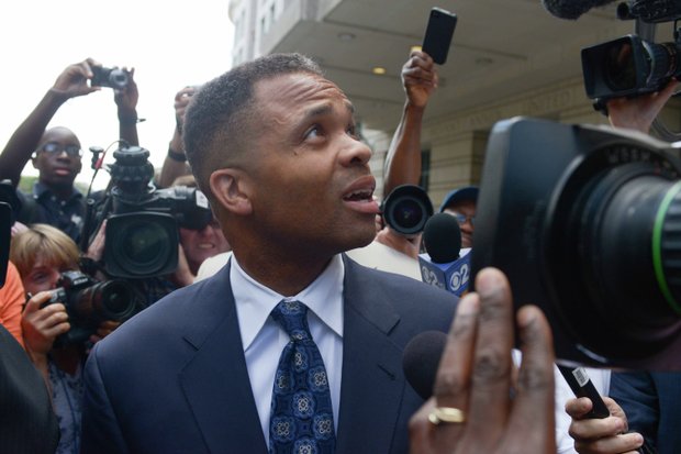 Former Illinois Rep. Jesse Jackson Jr. looks back at the U.S. District Courthouse in D.C., on Wednesday, Aug. 14 while walking to his vehicle after he was sentenced to 30 months in prison for misuse of campaign funds.