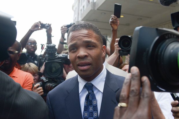 Former Illinois Rep. Jesse Jackson Jr. is surrounded by members of the press and onlookers as he leaves the U.S. District Courthouse in D.C., on Wednesday, Aug. 14 after he was sentenced to 30 months in prison for misuse of campaign funds.