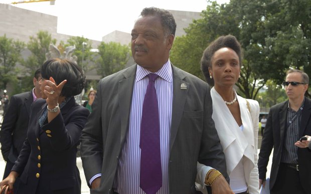 The Rev. Jesse Jackson Sr. leaves the U.S. District Courthouse in D.C., on Wednesday, Aug. 14 with his daughter Jacqueline (right) after attending sentencing hearings for Former Illinois Rep. Jesse Jackson Jr. and his wife Sandi for felony charges related to misuse of campaign funds and failing to report taxable income.