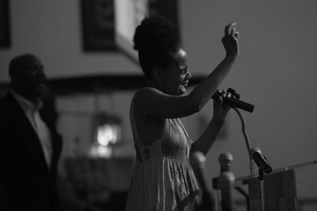 Ayanna Gregory performs ‘Lift Every Voice and Sing’ during a pre-march rally celebration at Union Temple Baptist Church in Southeast on Tuesday, August 20.