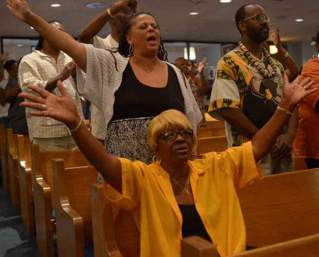 Guests listen to speakers discuss the importance of the March on Washington 50 years ago and its continued importance today at a pre-march rally celebration at Union Temple Baptist Church in Southeast on Tuesday, August 20.