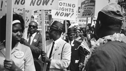 Protestors holding signs during the 1963 March on Washington.