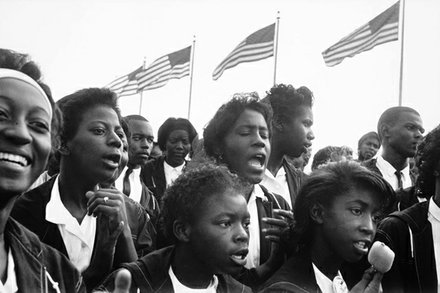 A group of people singing together during the 1963 March on Washington.