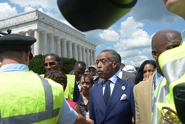 Rev. Al Sharpton, center, and other dignitaries en route to the Washington Monument after speaking during the March on Washington 50th Anniversary on Sat., August 24.