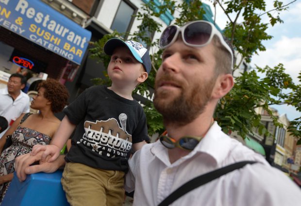 Oscar, 2, enjoys during the 2013 Adams Morgan Day festivities in D.C. on Sunday, Sept. 8., with his father Jeff Bortolet, 32.