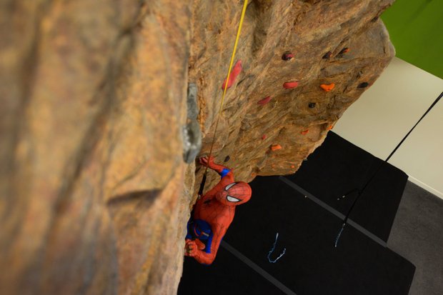 A man dressed as Spider-Man climbs the rock wall at the newly refurbished Anthony Bowen YMCA in Northwest D.C. after a ribbon-cutting ceremony on Monday, Sept. 9.