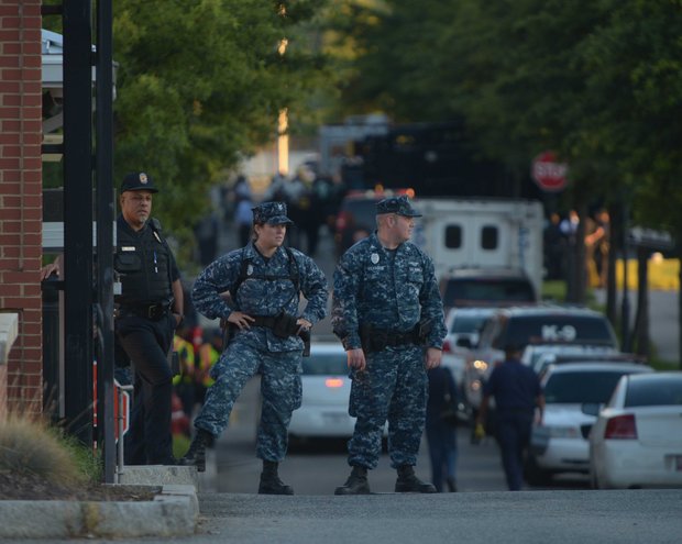 Military and federal police stand guard at the M Street entrance of the Washington Navy Yard on Monday, Sept. 16, after a gunman went on a rampage and killed 12 people.