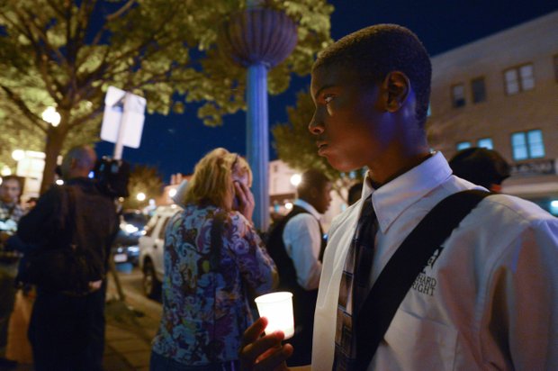 Derrick Hardy, 14, a student at the Richard Wright Public Charter School for Journalism and Media Arts in D.C., stands in silence during a candlelight vigil for the victims of the Washington Navy Yard shooting at 8th and M streets in Southeast on Tuesday, Sept. 17.