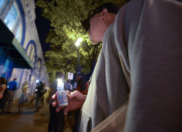 A man holds a candle during a vigil for the victims of the Washington Navy Yard shooting at 8th and M streets in Southeast on Tuesday, Sept. 17.