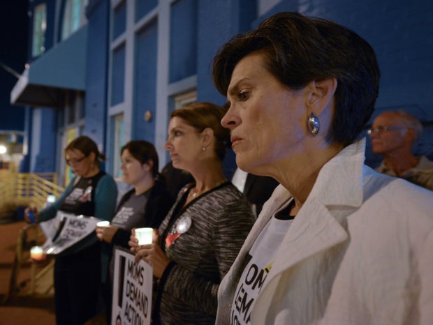 Grace Terpstra, a member of Moms Demand Action, stands in silence during a candlelight vigil for the victims of the Washington Navy Yard shooting at 8th and M streets in Southeast on Tuesday, Sept. 17.