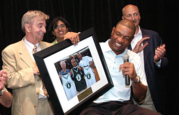 Action for Boston Community Development president and CEO John J. Drew (left)giving former Boston Celtics coach Doc Rivers (right) a framed photo plaque as thanks for his support of ABCD at the organization’s Hoop Dreams fundraiser at TD Garden.