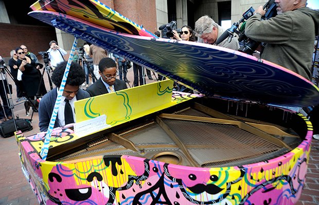 Two Boston Arts Academy students play a duet on the piano installed on City Hall Plaza.
