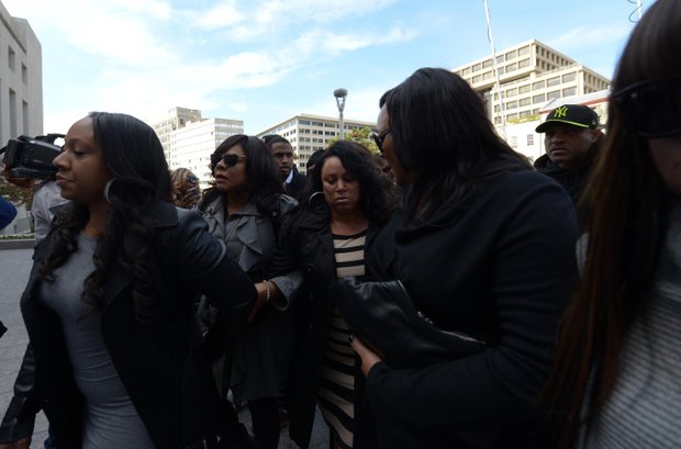 Joyce Hawkins (center), mother of singer Chris Brown, is surrounded by family and security on Oct. 28 as she enters D.C. Superior Court in support of her son after a weekend arrest for assault charges in the District.