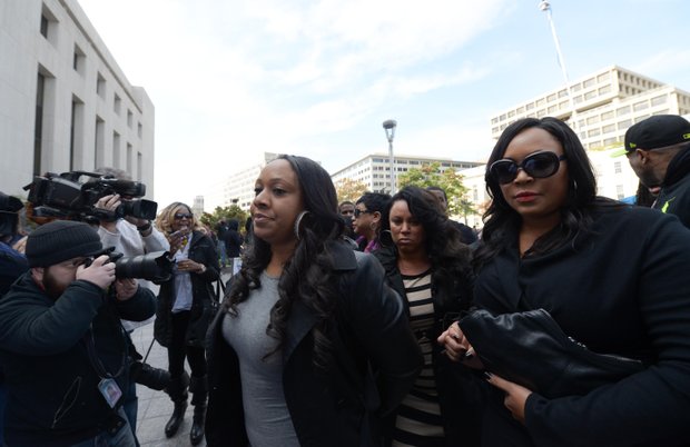 Joyce Hawkins (center), mother of singer Chris Brown, is surrounded by family and security on Oct. 28 as she enters D.C. Superior Court in support of her son after a weekend arrest for assault charges in the District.