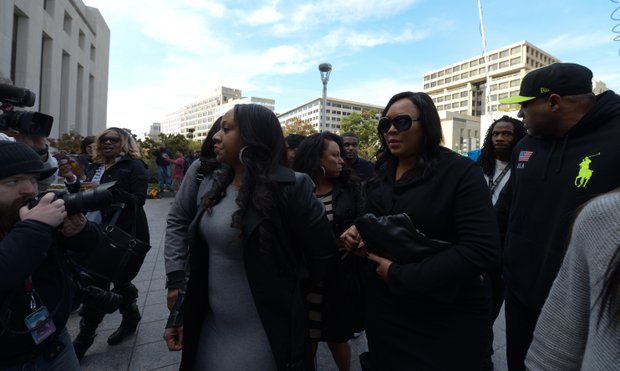 Joyce Hawkins (center), mother of singer Chris Brown, is surrounded by family and security on Oct. 28 as she enters D.C. Superior Court in support of her son after a weekend arrest for assault charges in the District.