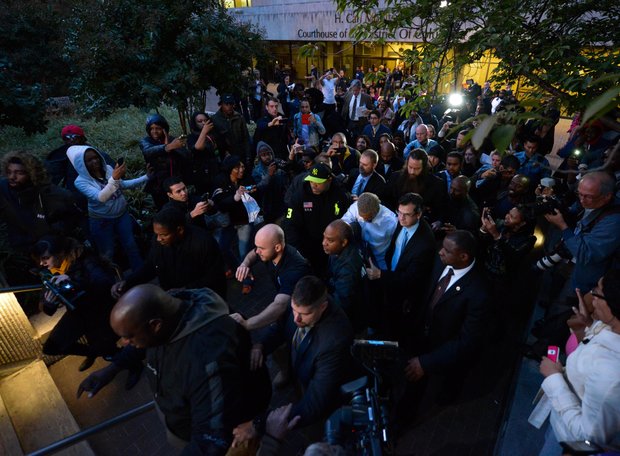 Singer Chris Brown (center), surrounded by U.S. Marshals and security personnel, makes his way through fans and members of the press on Oct. 28 after he was released from D.C. Superior Court following a weekend arrest for assault charges.