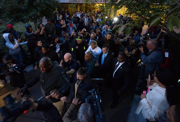 Singer Chris Brown (center), surrounded by U.S. Marshals and security personnel, makes his way through fans and members of the press on Oct. 28 after he was released from D.C. Superior Court following a weekend arrest for assault charges.