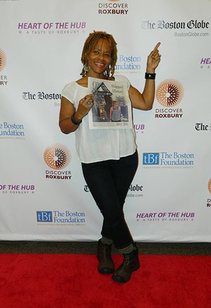 Artist Ife Franklin showing off article in newspaper!
