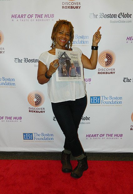 Artist Ife Franklin showing off article in newspaper!