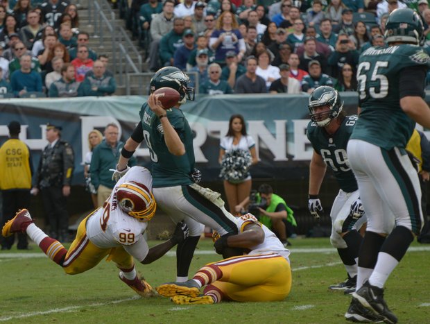 Washington Redskins outside linebacker Brian Orakpo and defensive end Jarvis Jenkins wrap Philadelphia quarterback Nick Foles for a sack.