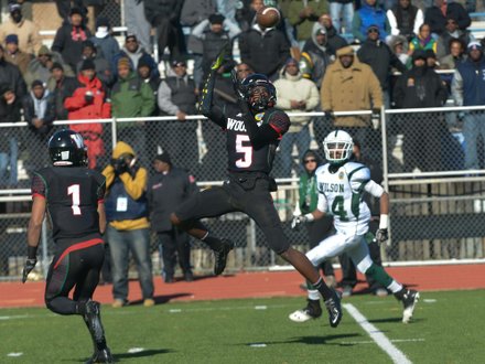 H.D. Woodson defensive back DuWayne Johnson intercepts a pass in the third quarter during the 44th Annual Turkey Bowl, a Thanksgiving tradition, in Southeast on Thursday, Nov. 28. H.D. Woodson defeated Wilson, 25-13.