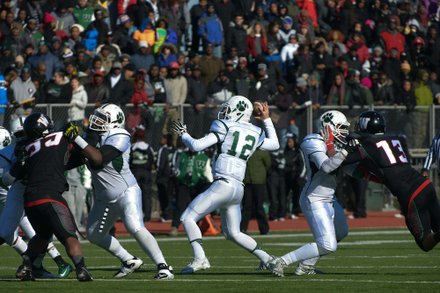 Wilson quarterback Scott Beumel prepares to pass during the 44th Annual Turkey Bowl, a Thanksgiving tradition, in Southeast on Thursday, Nov. 28. H.D. Woodson defeated Wilson, 25-13.