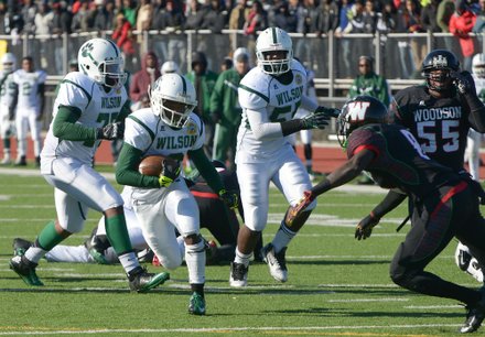 Wilson running back Larry Frazier rushes for a gain in the fourth quarter during the 44th Annual Turkey Bowl, a Thanksgiving tradition, in Southeast on Thursday, Nov. 28. H.D. Woodson defeated Wilson, 25-13.