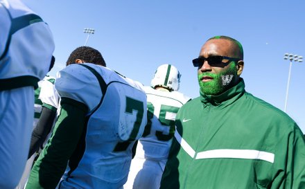 Wilson assistant coach Dudley Irvin shows school spirit at the 44th Annual Turkey Bowl, a Thanksgiving tradition, in Southeast on Thursday, Nov. 28. H.D. Woodson defeated Wilson, 25-13.