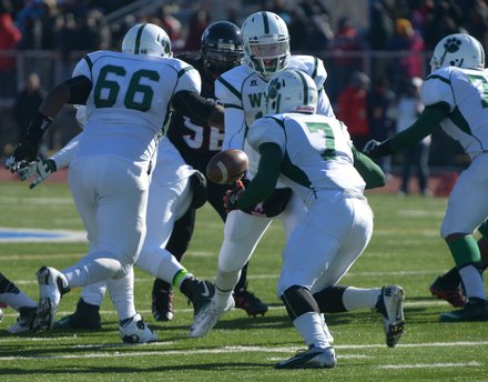 Wilson quarterback Scott Beumel prepares to hand off to running back Abdul Adams during the 44th Annual Turkey Bowl, a Thanksgiving tradition, in Southeast on Thursday, Nov. 28. H.D. Woodson defeated Wilson, 25-13.