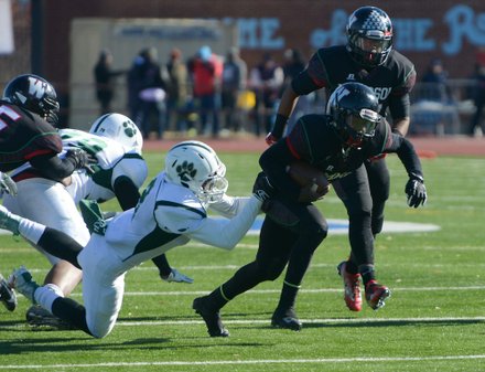 H.D. Woodson quarterback Rashad Cooper tries to break a tackle in the first quarter during the 44th Annual Turkey Bowl, a Thanksgiving tradition, in Southeast on Thursday, Nov. 28. H.D. Woodson defeated Wilson, 25-13.