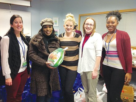 The Neponset Health Center distributes Thanksgiving meals each year with help from a hunger assistance grant from Partners HealthCare. (l-r): Julia Lily, social worker Neponset Health Center; Camille Benson, patient, Neponset Health Center; Ray Perrin, social worker intern, Neponset Health Center; Taffidy Davis, social worker intern, Neponset Health Center; and Cierra Morson, youth peer leader, Neponset Health Center. (Photo courtesy Neponset Health Center)